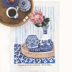 Tea Towel of protea in blue white vase on rattan tray