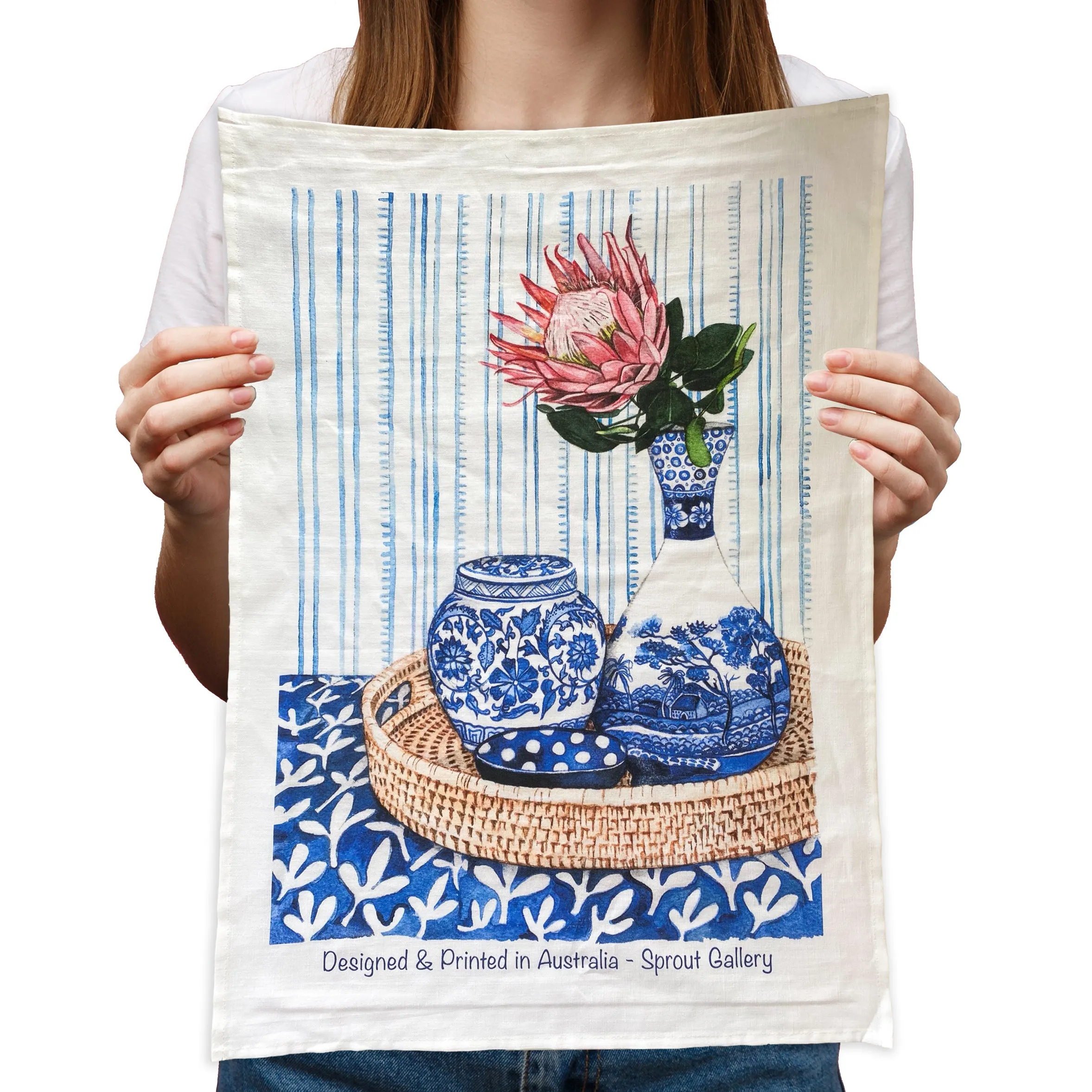 Tea Towel of protea in blue white vase on rattan tray